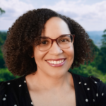 Danielle Jones, MA, LAC, LPC, NCC is a black female therapist, with glasses, smiling