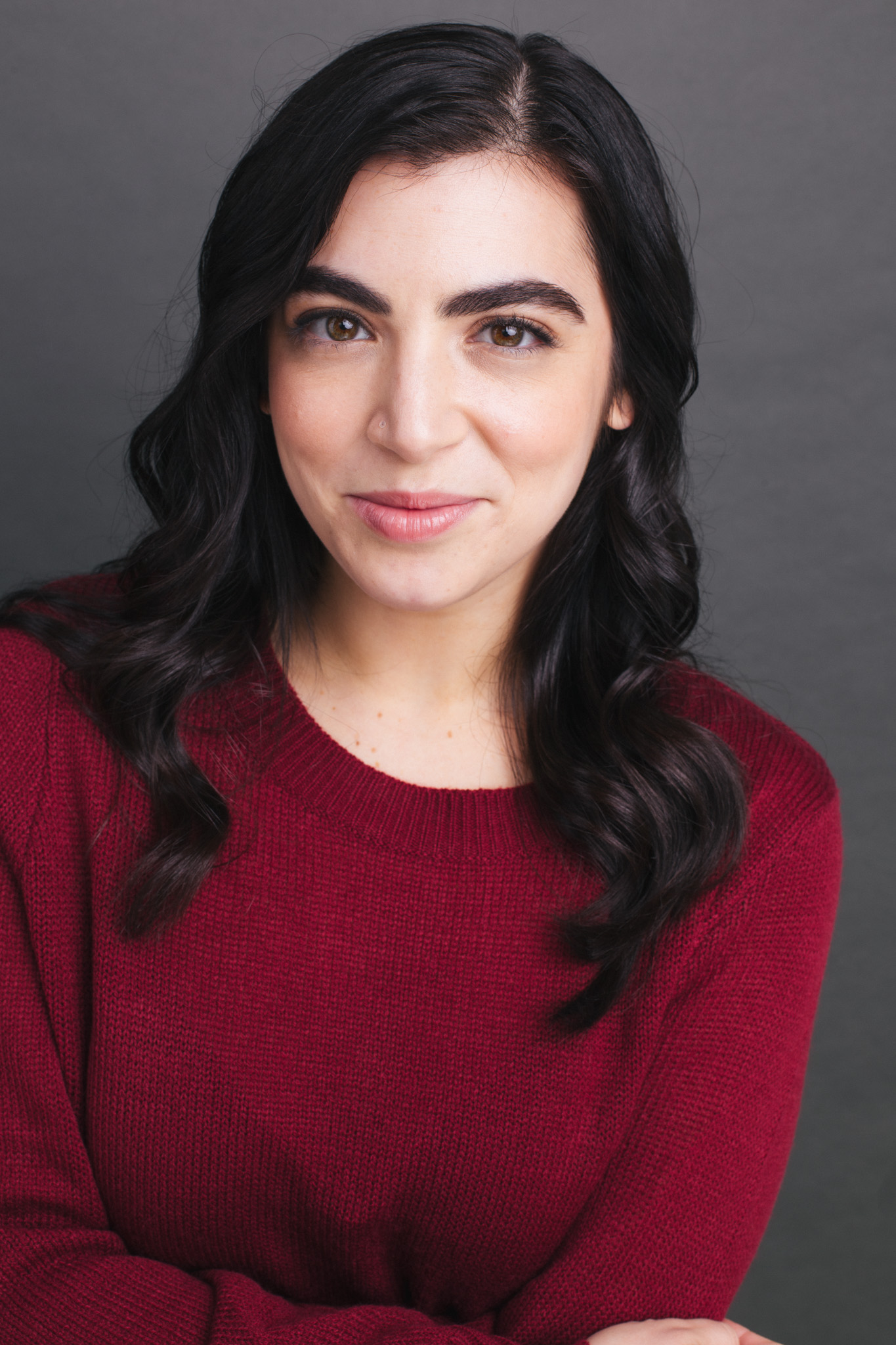 Image description: A headshot of Laura Potel, LCAT, smiling, in a red sweater.